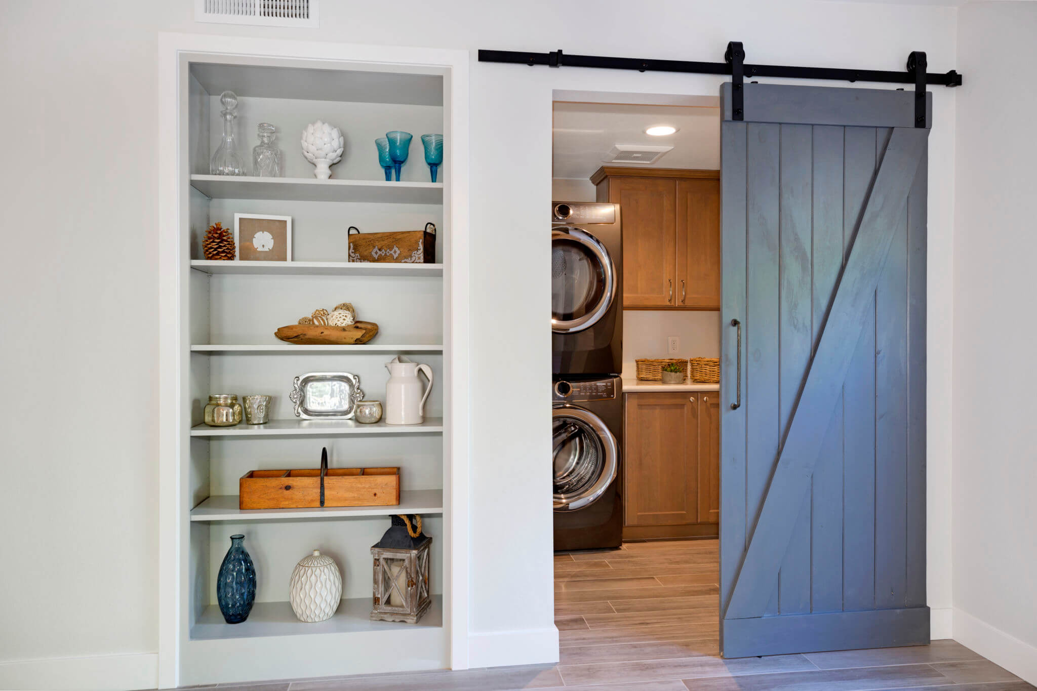 laundry room with barn door and cabinet storage