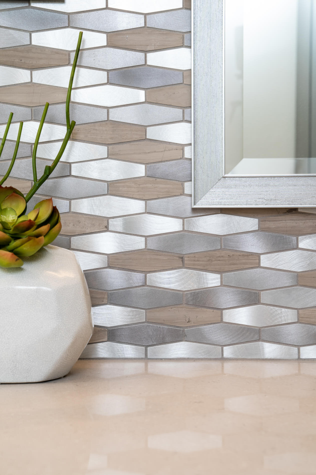Bathroom wall with silver and brown tiles