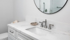 Bathroom Remodel – Sink with round mirror and white cabinets