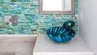 Glass tile backsplash with beach theme in bathroom remodel