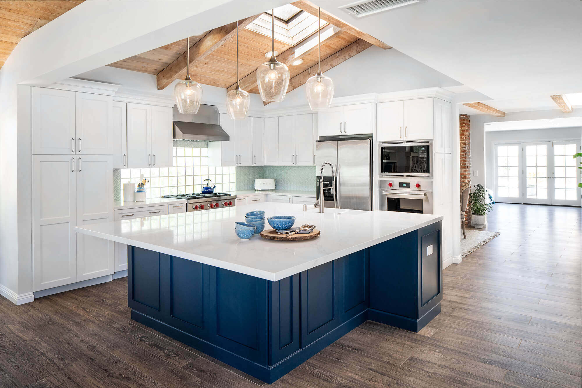 remodeled kitchen with classic blue island and quartz countertops.