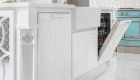 Custom cabinets using luxury design to disguise dishwasher.