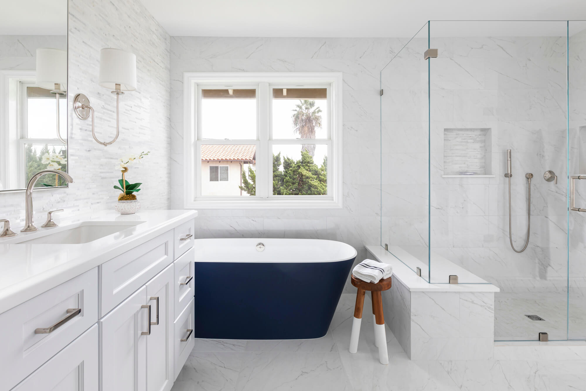 White bathroom with blue tub