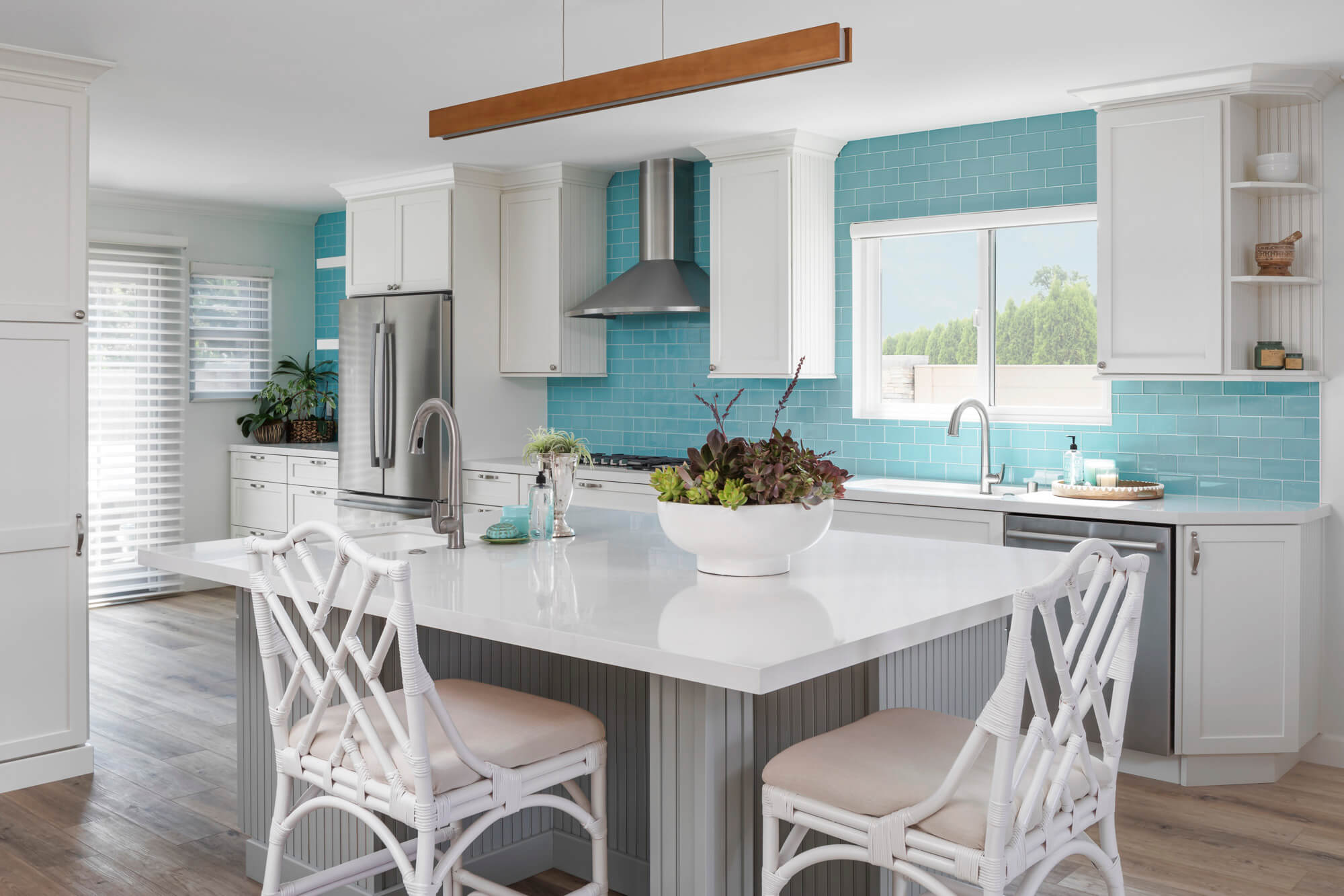 White kitchen with blue tiling.