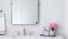 Gray Vanity with white marble backsplash in bathroom remodel