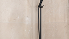 Walk-in Shower with black fixtures in remodel