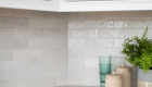 Ceramic Cloe white subway tile backsplash in kitchen remodel