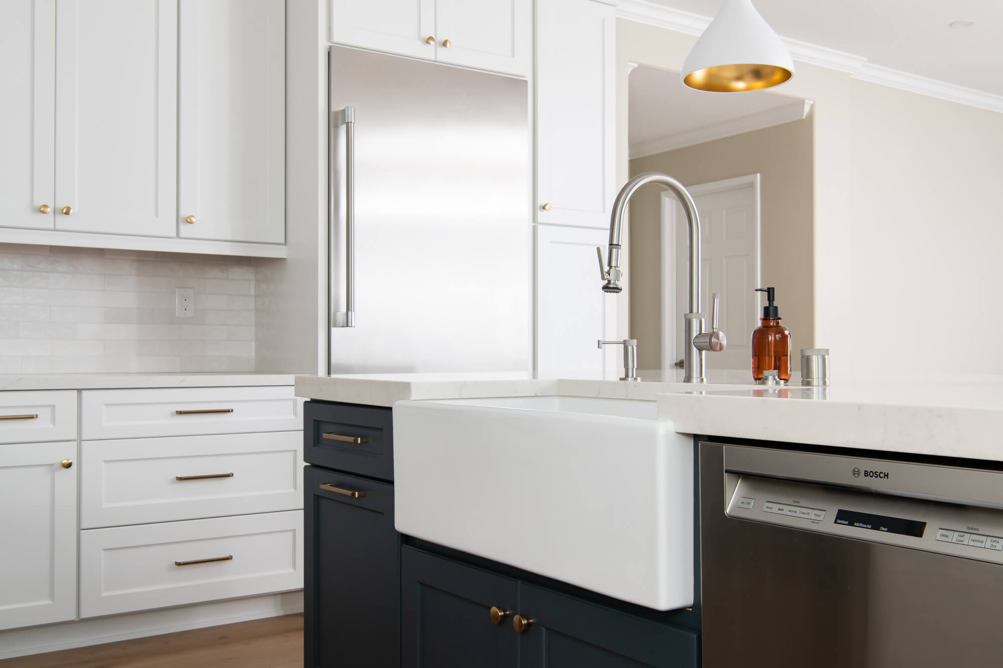 White farmhouse kitchen sink and blue cabinets