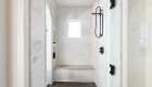 Primary bathroom remodel with honed marble shower tile design