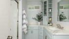 Double sink with seafoam green cabinetry