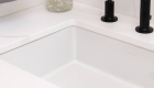 quartz-countertop-and-backsplash-wide-spread-sink-faucet-in-matte-black