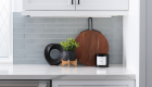 Sessemo-glossy-subway-glass-tile-in-ice-gray-painted-glass-tile-under-cabinet-lights-and-plugs