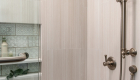 porcelain-tiles-in-brushed-spritzer-by-marazzi-with-satin-nickel-shower-hardware-and-fluerco-acrylic-alcove-bathtub