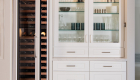 side-nook-with-clear-glass-inserts-renner-shaker-doors-and-full-sized-wine-refrigerator