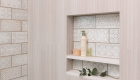 accent-wall-and-niche-with-random-mix-of-patterns-staggered-porcelain-tiles-in-Polished-patina