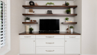 omega-dynasty-cabinets-in-pearl-white-with-wood-countertop-floating-shelves-satin-nickel-pulls