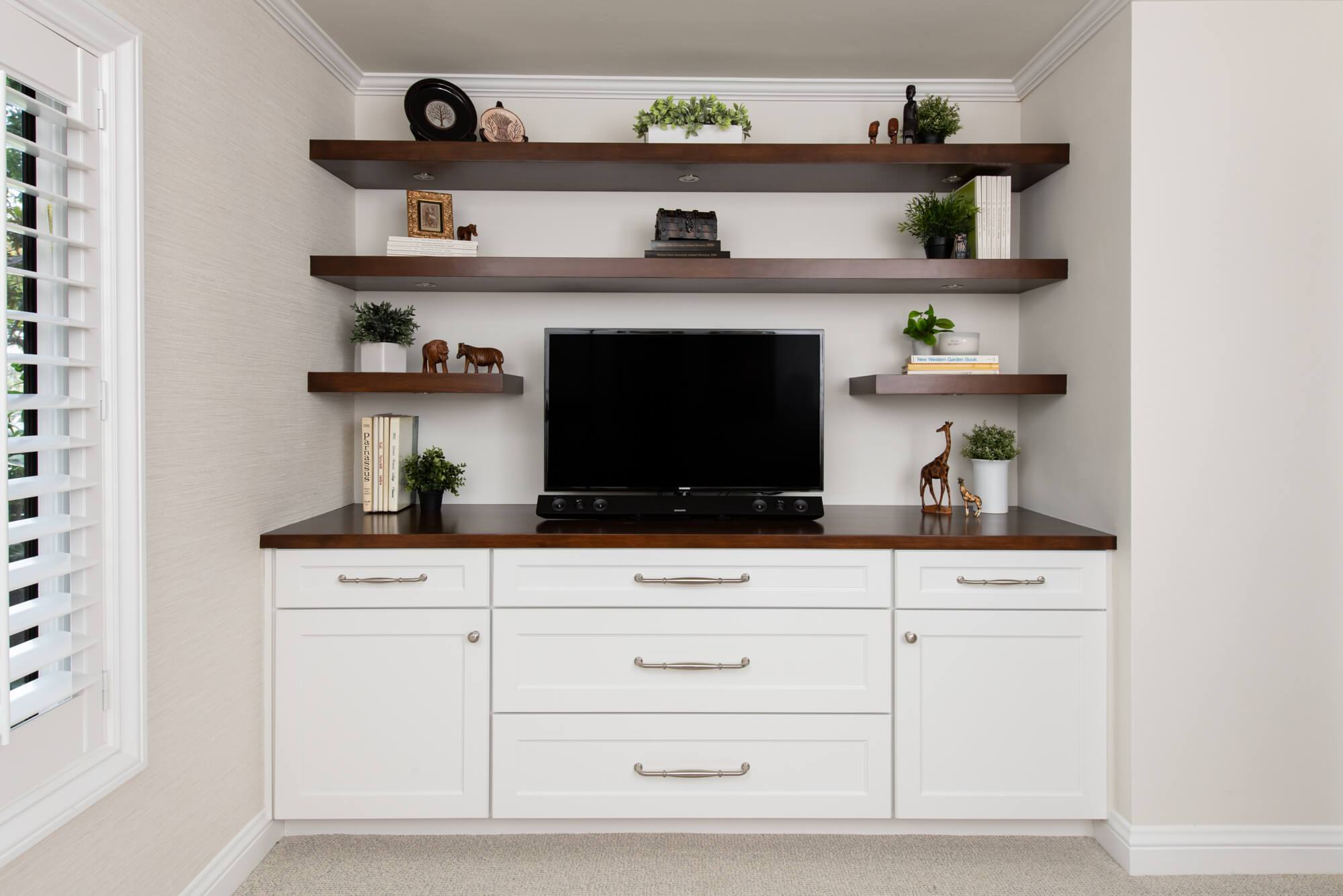 omega-dynasty-cabinets-in-pearl-white-with-wood-countertop-floating-shelves-satin-nickel-pulls