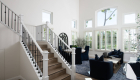 custom-white-handrails-with-satin-black-double-knuckle-iron-balusters-and-nosing