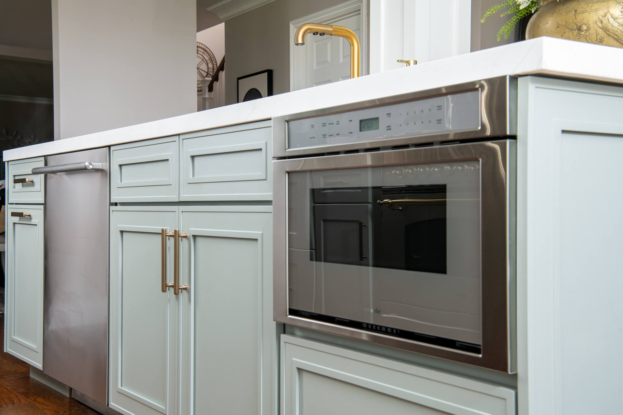 kitchen-island-in-maho-bay-with-kohler-purist-vibrant-moderne-brass-faucet-undermount-sink-built-in-Thermador-microwave-and-dishwasher