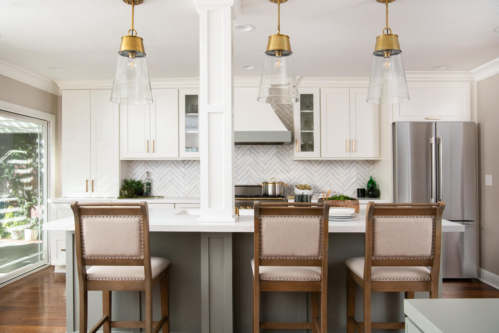 island-with-seating-for-3-with-rubbed-brass-one-light-pendants-with-clear-glass-shades