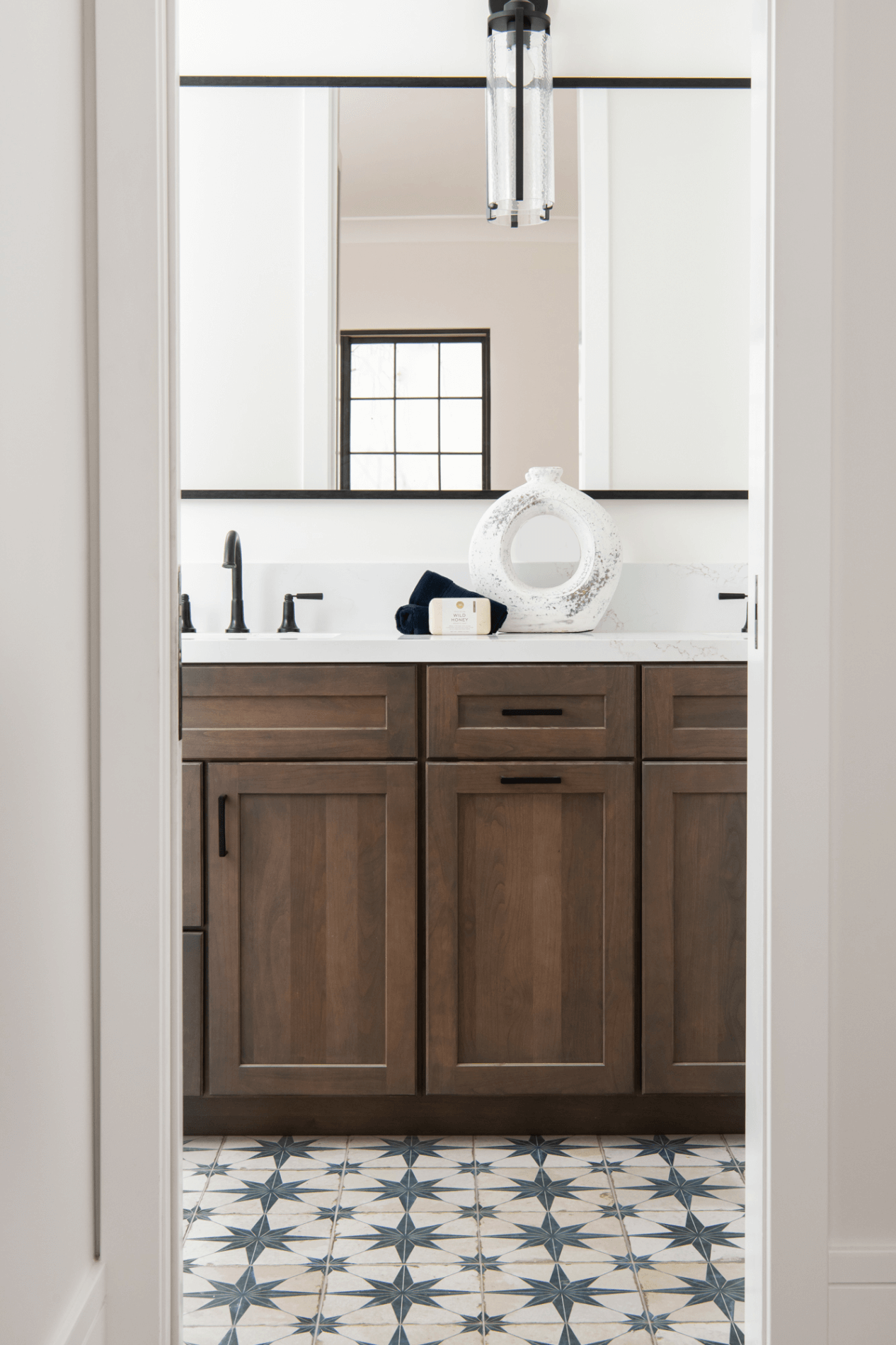 Arch-vanity-mirror-and-liquid-glass-vanity-sconces-in-matte-black