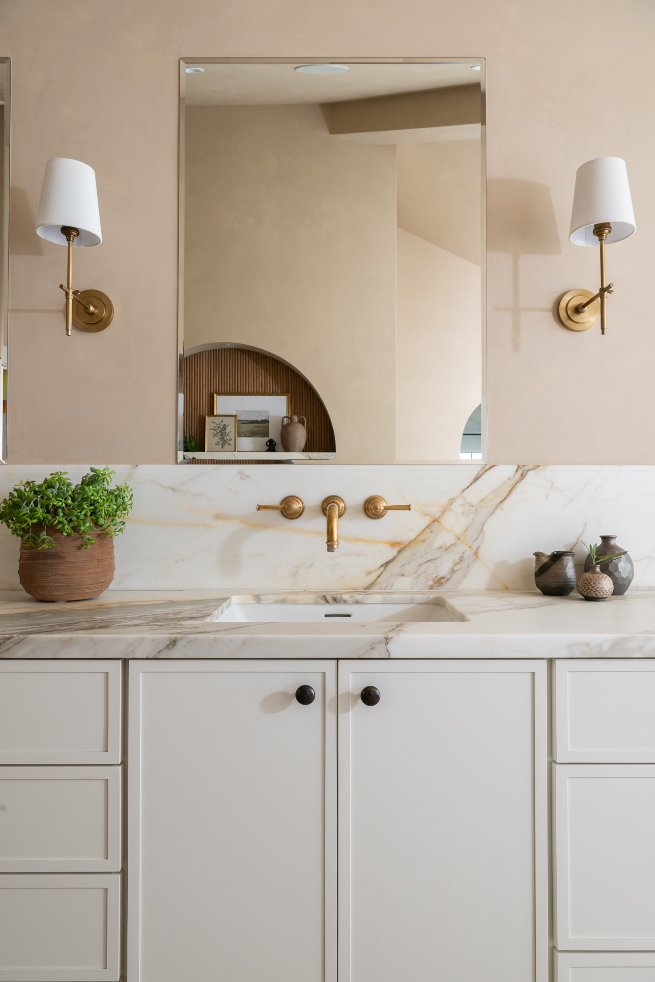 simple-rectangular-mirrors-and-sconces-sit-above-vanity