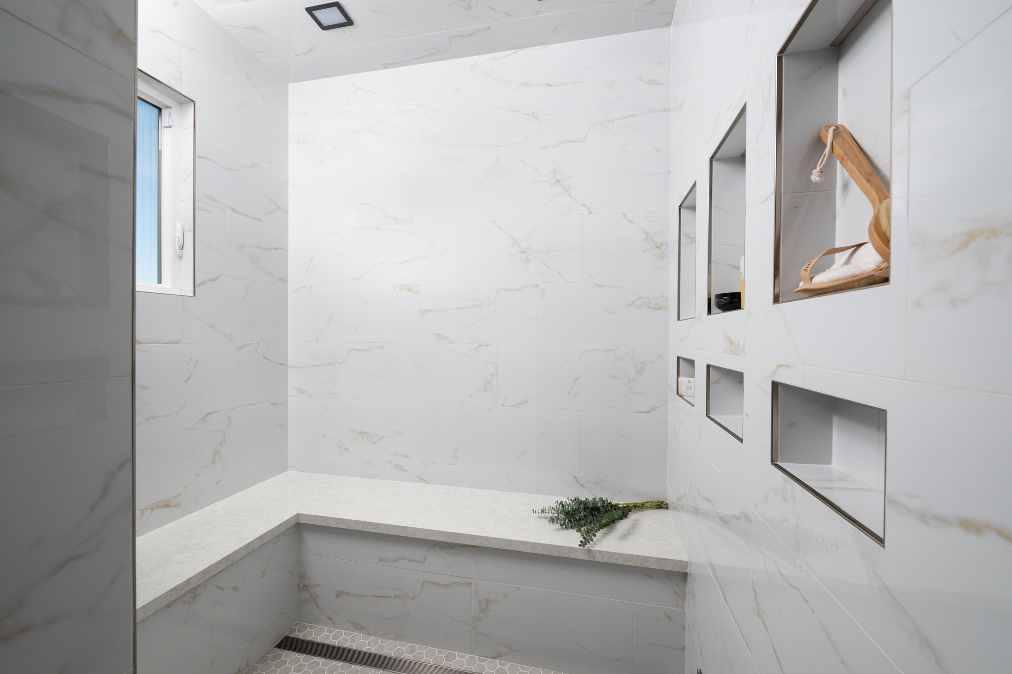 steam-shower-features-a-shower-bench-six-custom-niches-linear-drain