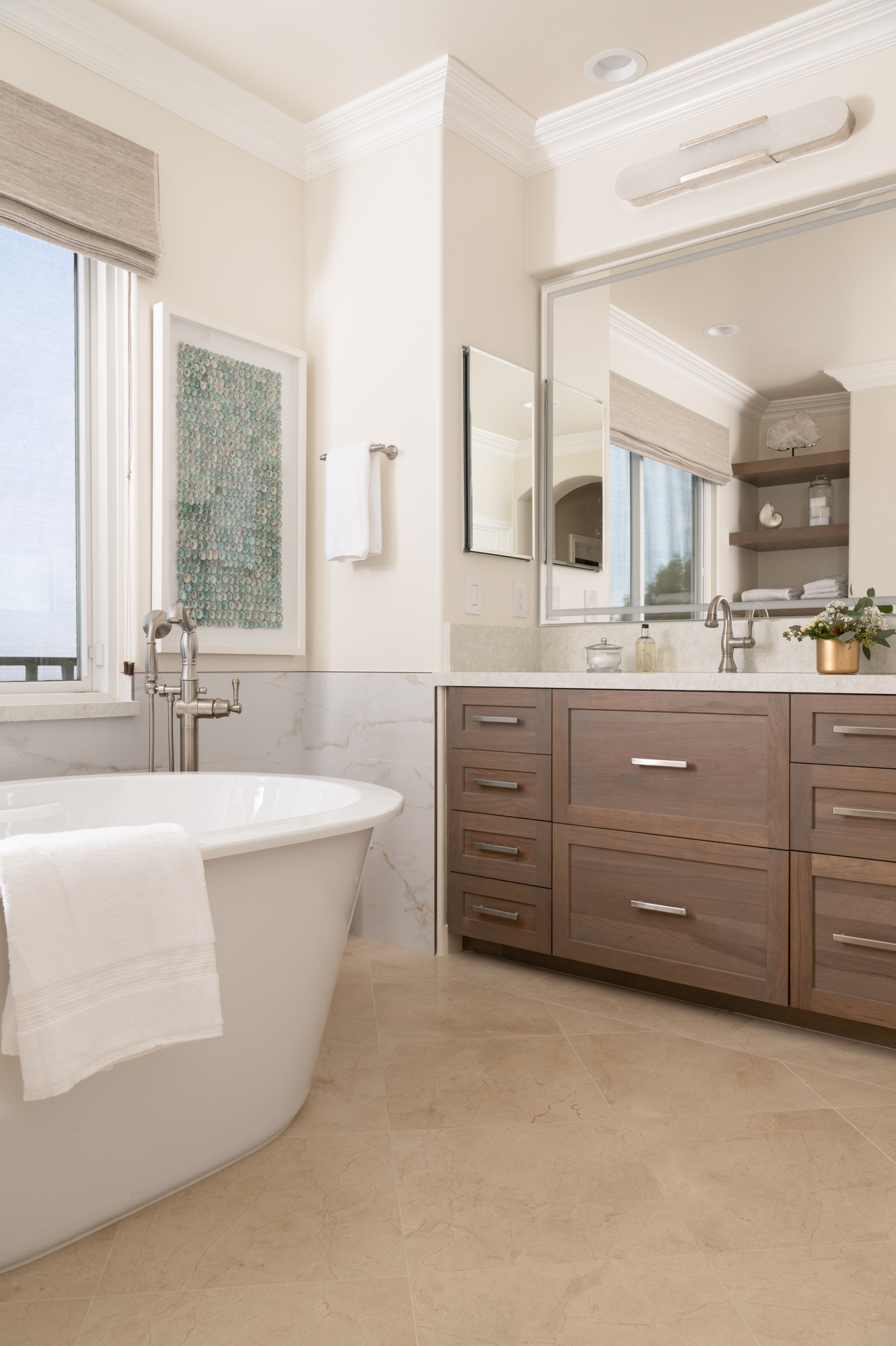 polished-nickel-elongated-alabaster-sconce-over-LED-mirror