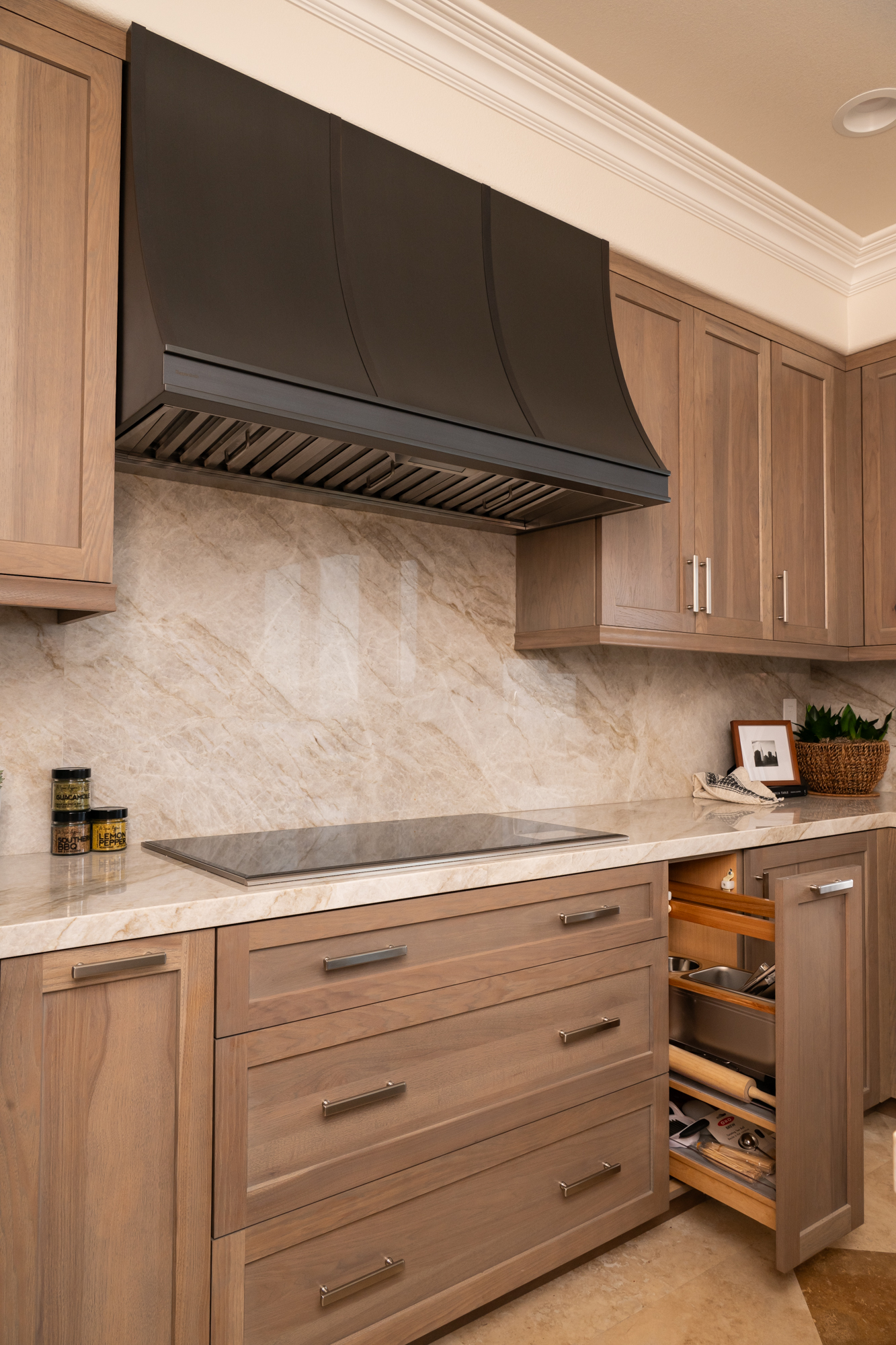 cabinetry-includes-custom-spice-rack-next-to-induction-cooktop