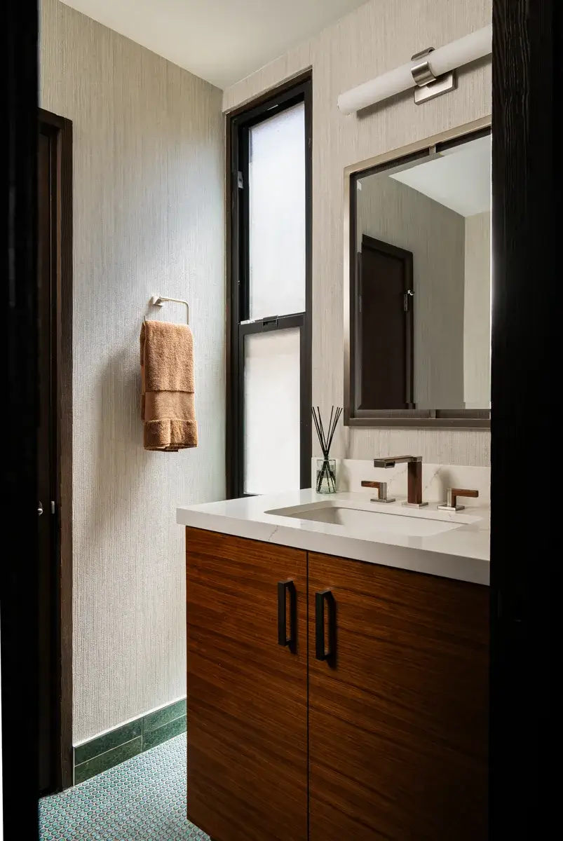 Sea-Pointe-Design-And-Remodel-powder-and-guest-bath-walls-wallpapered-in-a-textured-vinyl-called-Tiber-Glint-resembling-striped-canvas-fabric