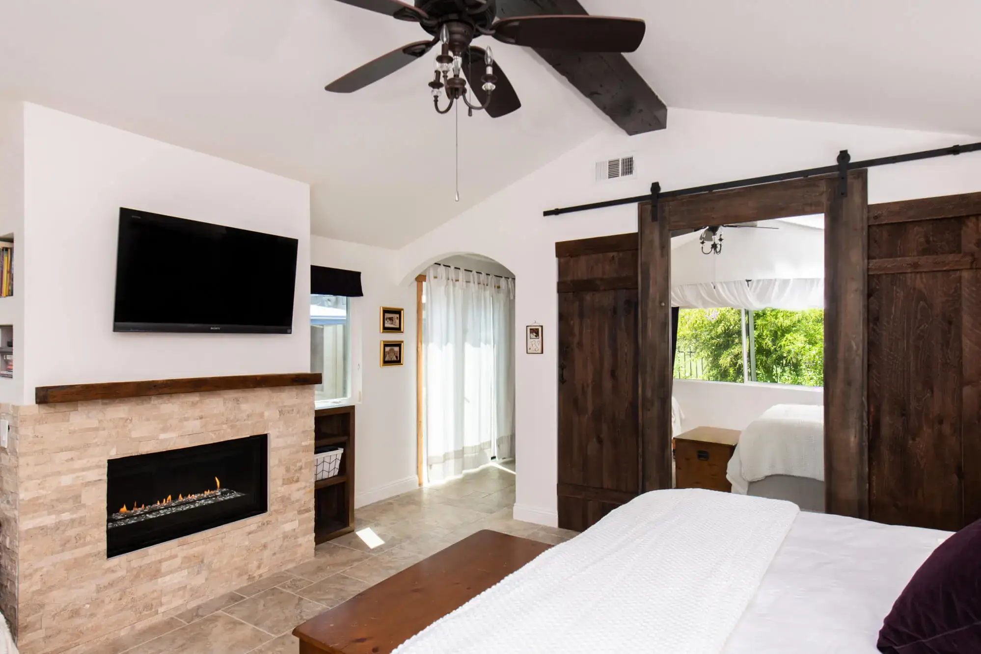 Room Addition Remodel in Mission Viejo with Stone Fireplace And A Barndoor Closet