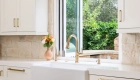wash-area-features-a-white-farmhouse-sink-with-Smart-Touch-single-handle-pull-down-faucet-in-Luxe-Gold