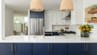 two-beaded-light-pendants-sit-over-kitchen-peninsula