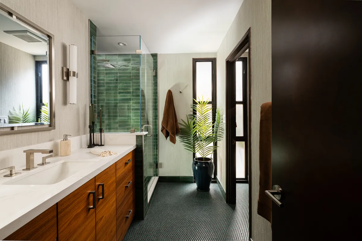 Earthy green tile makes a stylish accent for shower walls